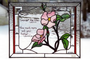 Stained glass with pink flowers and bible verse