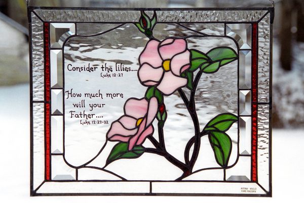 Stained glass with pink flowers and bible verse