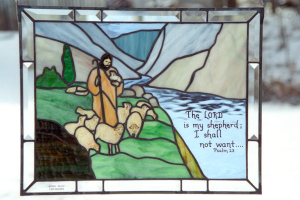 Stained glass with picture of shepherd and bible verse